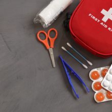 First aid kit on gray background