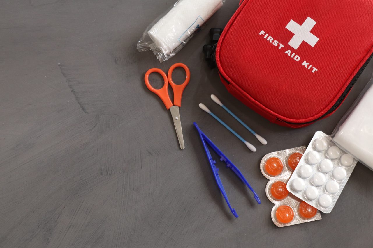 First aid kit on gray background