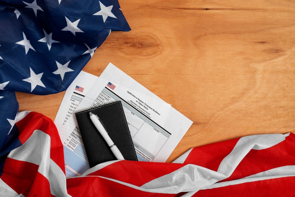 U.S. flag with paperwork and pen on wooden desk related to apostille process