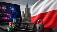 Laptop and smartphone with casino games beside poker chips, a padlock and the Polish flag